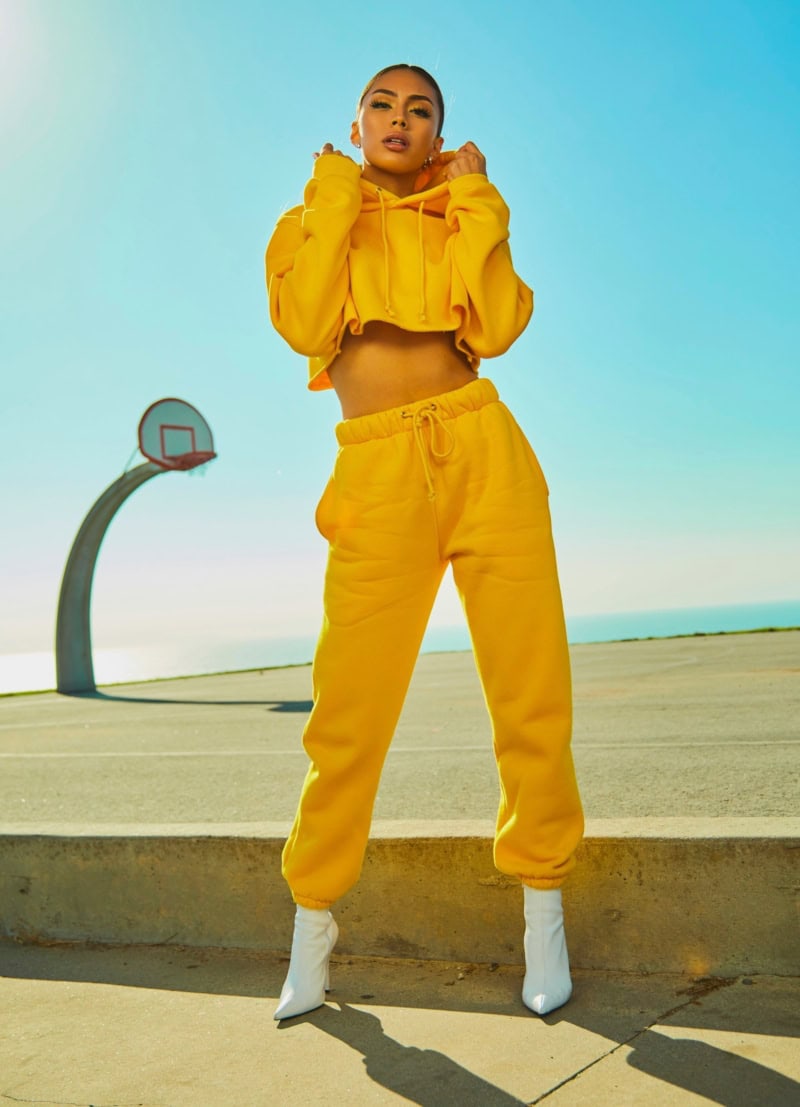 outdoor commercial headshot woman in yellow jumpsuit